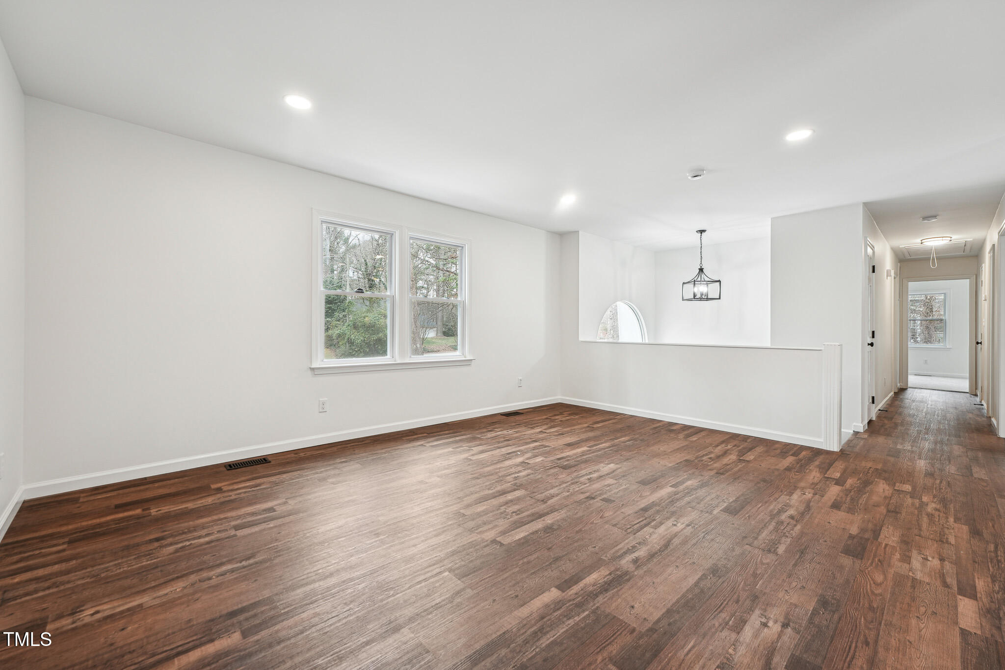 109 Chatterson Drive Raleigh, NC 27615 - Photo 5 of 51 an empty room with wooden floor bathroom and windows