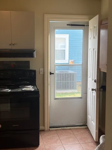 a stove top oven sitting inside of a kitchen