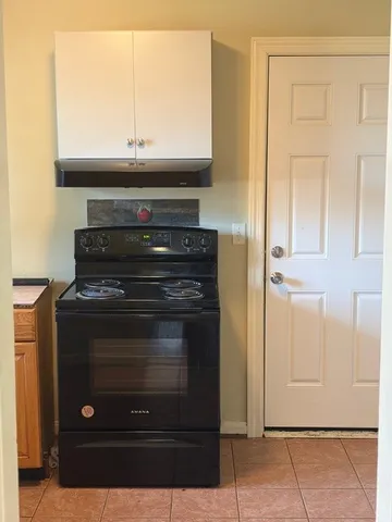 a stove top oven sitting inside of a kitchen