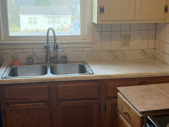 a kitchen with a sink and cabinets