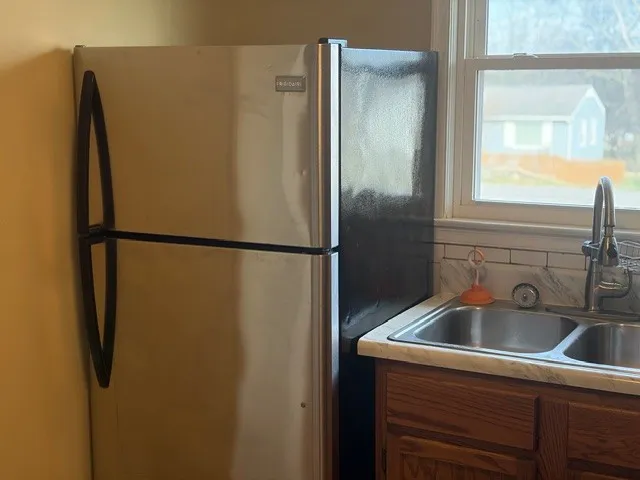 a kitchen with a refrigerator and a sink