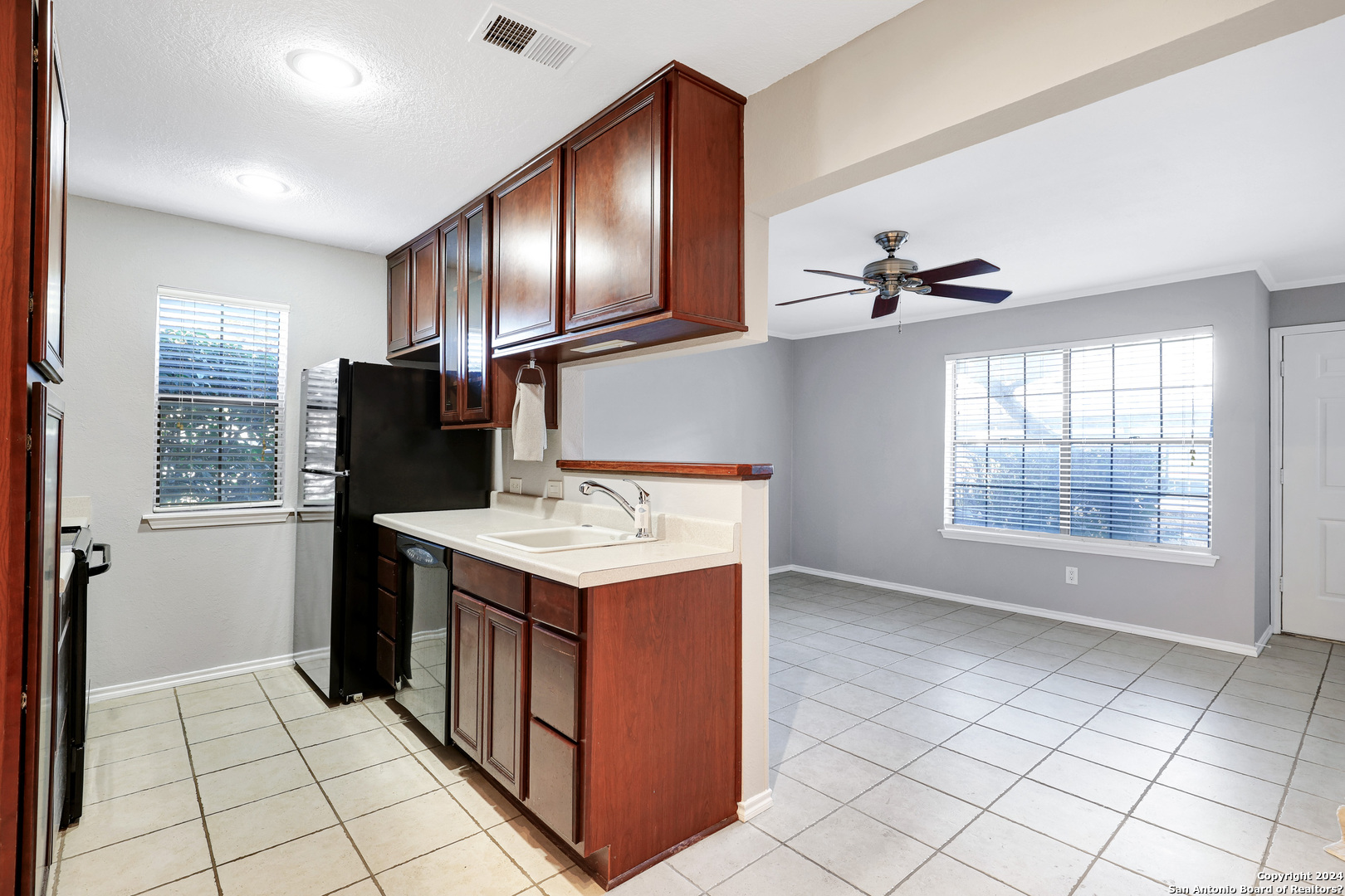 a kitchen with stainless steel appliances granite countertop a refrigerator and a sink