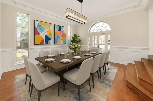 a view of a dining room with furniture wooden floor and a chandelier