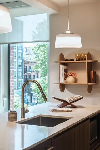 a kitchen with a sink and a stove next to a large window