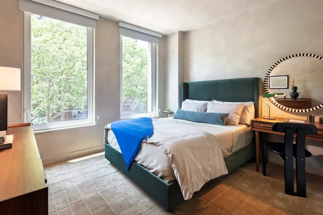 a bedroom with a bed and a window