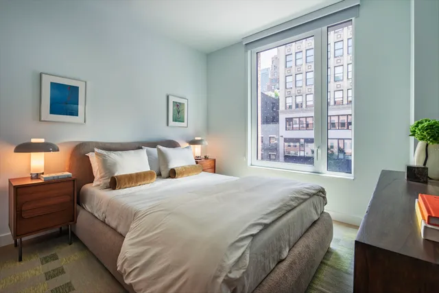 a bedroom with bed and a window