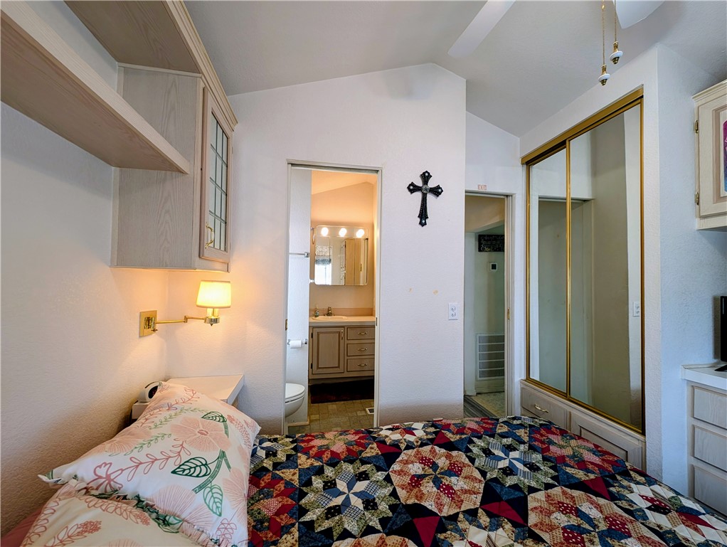 2000 Ramar Road, Unit 280 Bullhead City, AZ 86442 - Photo 39 of 63 a bedroom with a bed and a large mirror on the wall