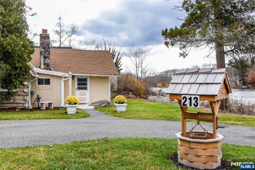 a view of a house with backyard and sitting area