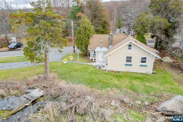 a view of a backyard with large trees and plants