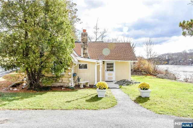 a view of a house with yard and sitting area