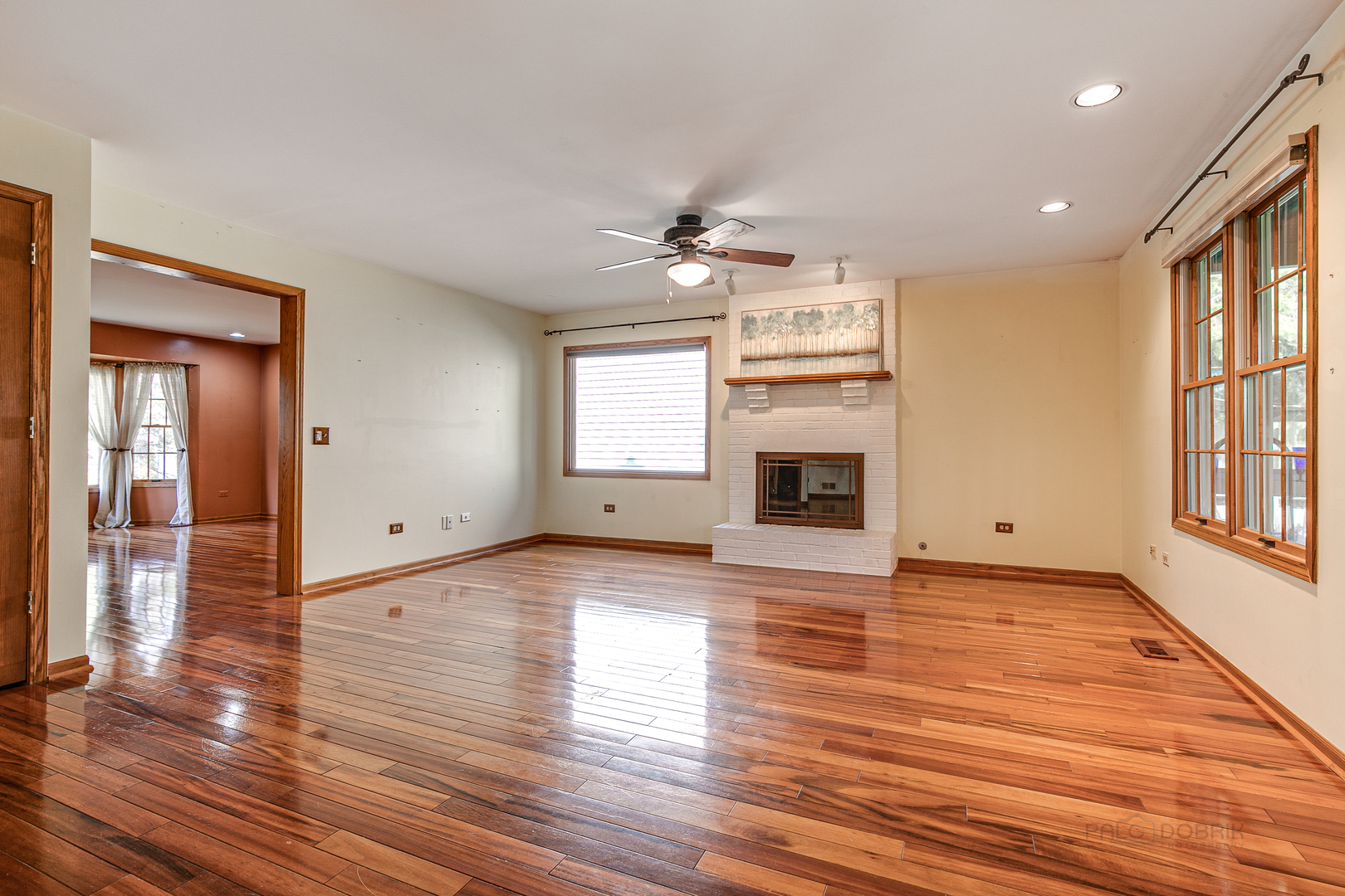 4727 Middle Road Gurnee, IL 60031 - Photo 11 of 29 an empty room with wooden floor fireplace and windows