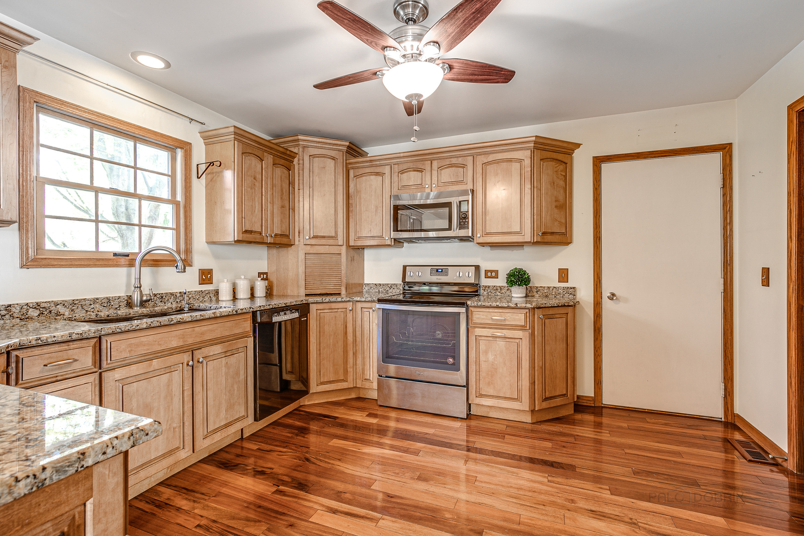 4727 Middle Road Gurnee, IL 60031 - Photo 7 of 29 a kitchen with granite countertop a stove cabinets and a refrigerator