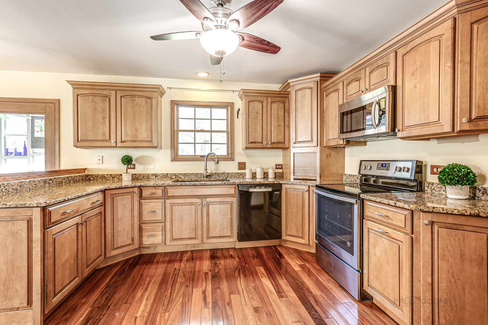 4727 Middle Road Gurnee, IL 60031 - Photo 8 of 29 a kitchen with stainless steel appliances granite countertop hardwood floor sink stove and granite counter top