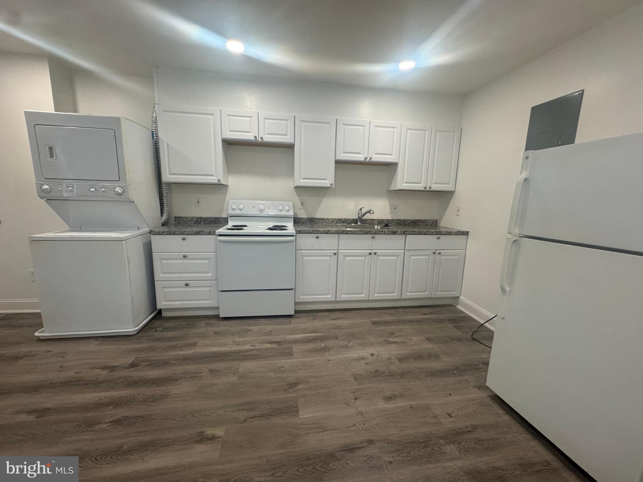 1527 Riggs Avenue Baltimore, MD 21217 - Photo 15 of 16 a kitchen with stainless steel appliances granite countertop a stove a sink and a refrigerator