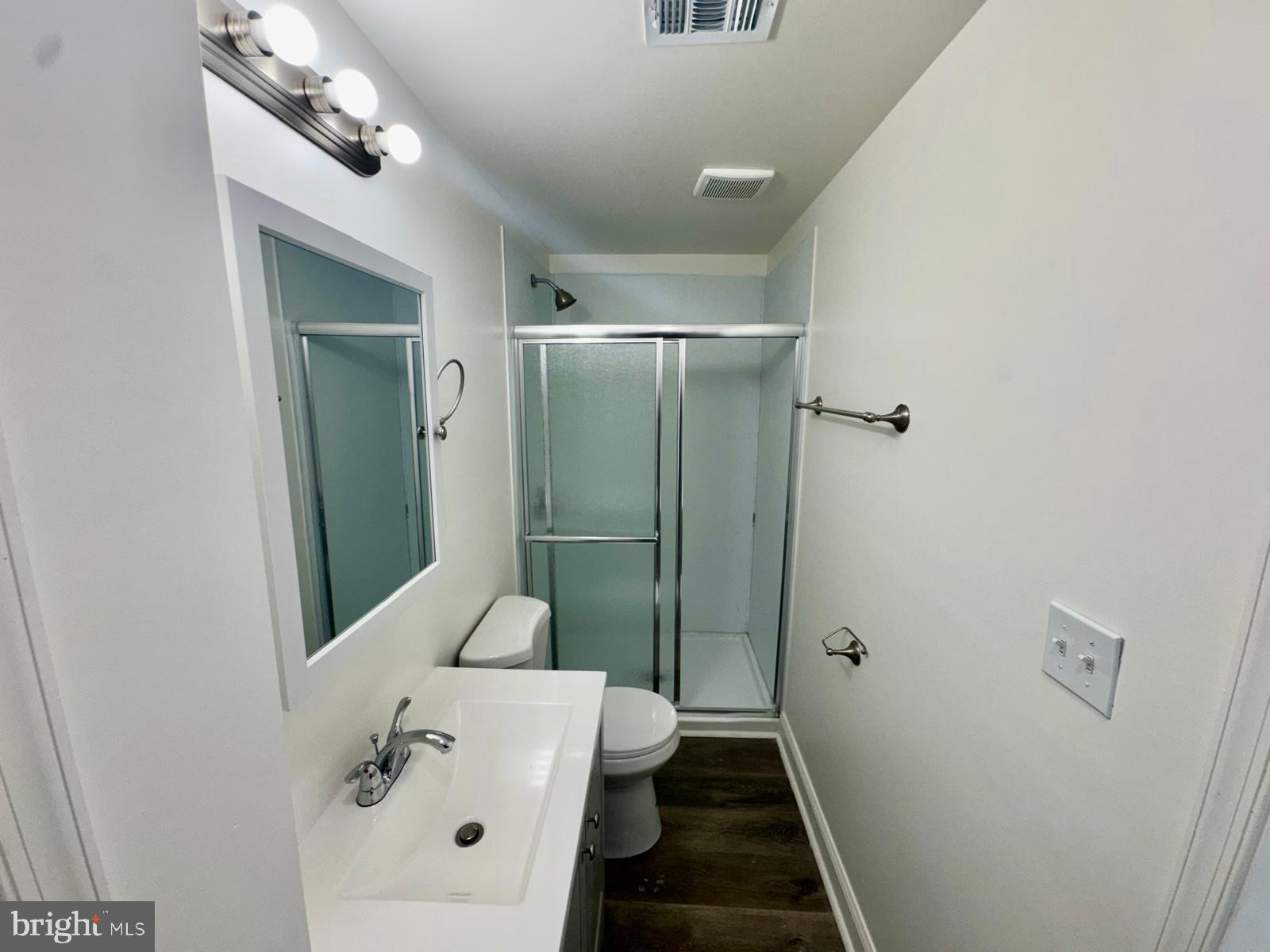 1527 Riggs Avenue Baltimore, MD 21217 - Photo 4 of 16 a bathroom with a sink and mirror with toilet