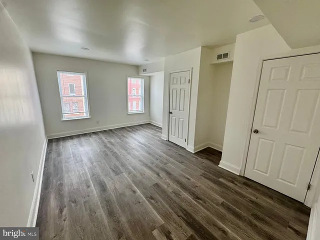 a view of a room with wooden floor and window