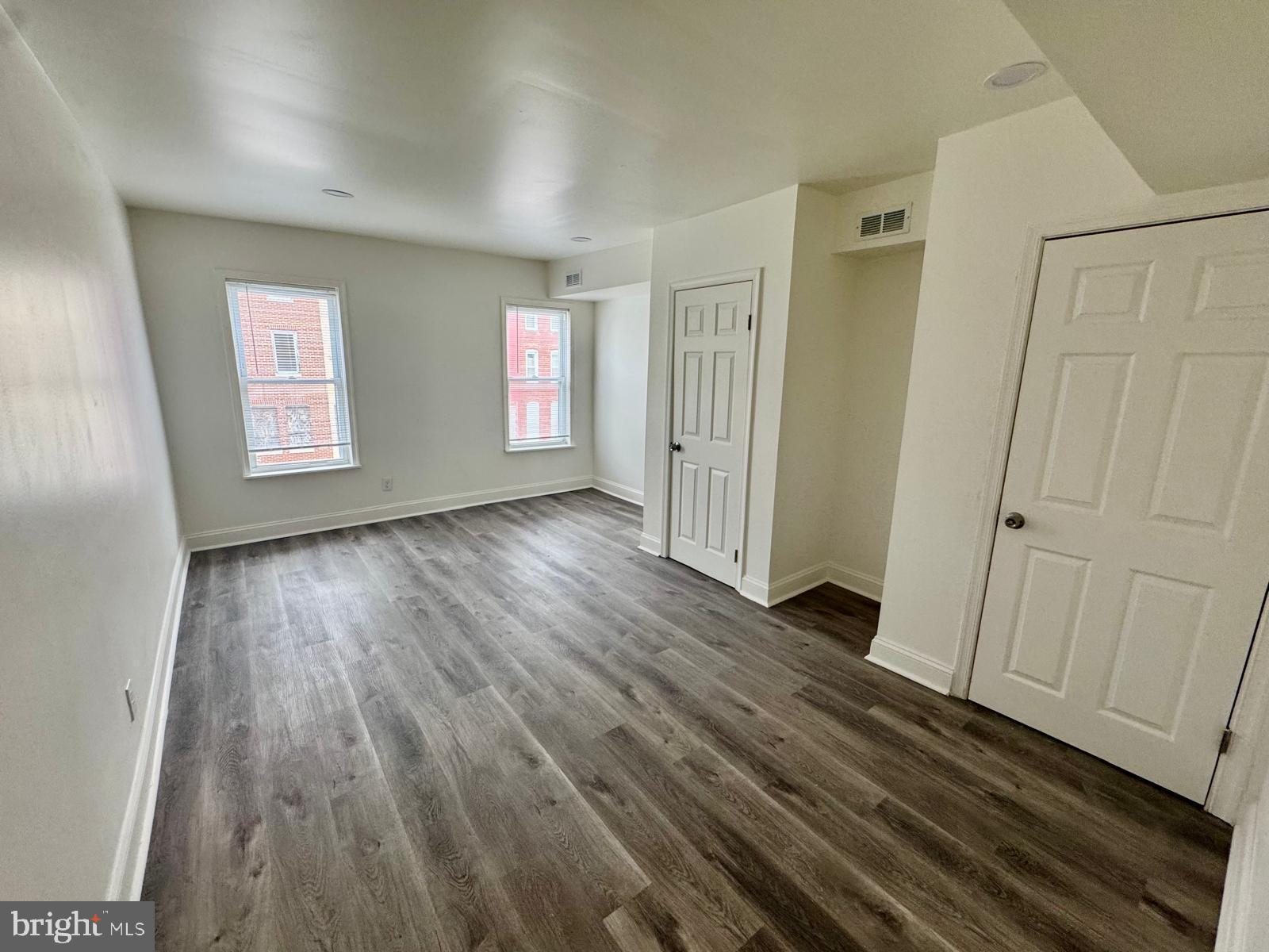 1527 Riggs Avenue Baltimore, MD 21217 - Photo 5 of 16 a view of a room with wooden floor and window