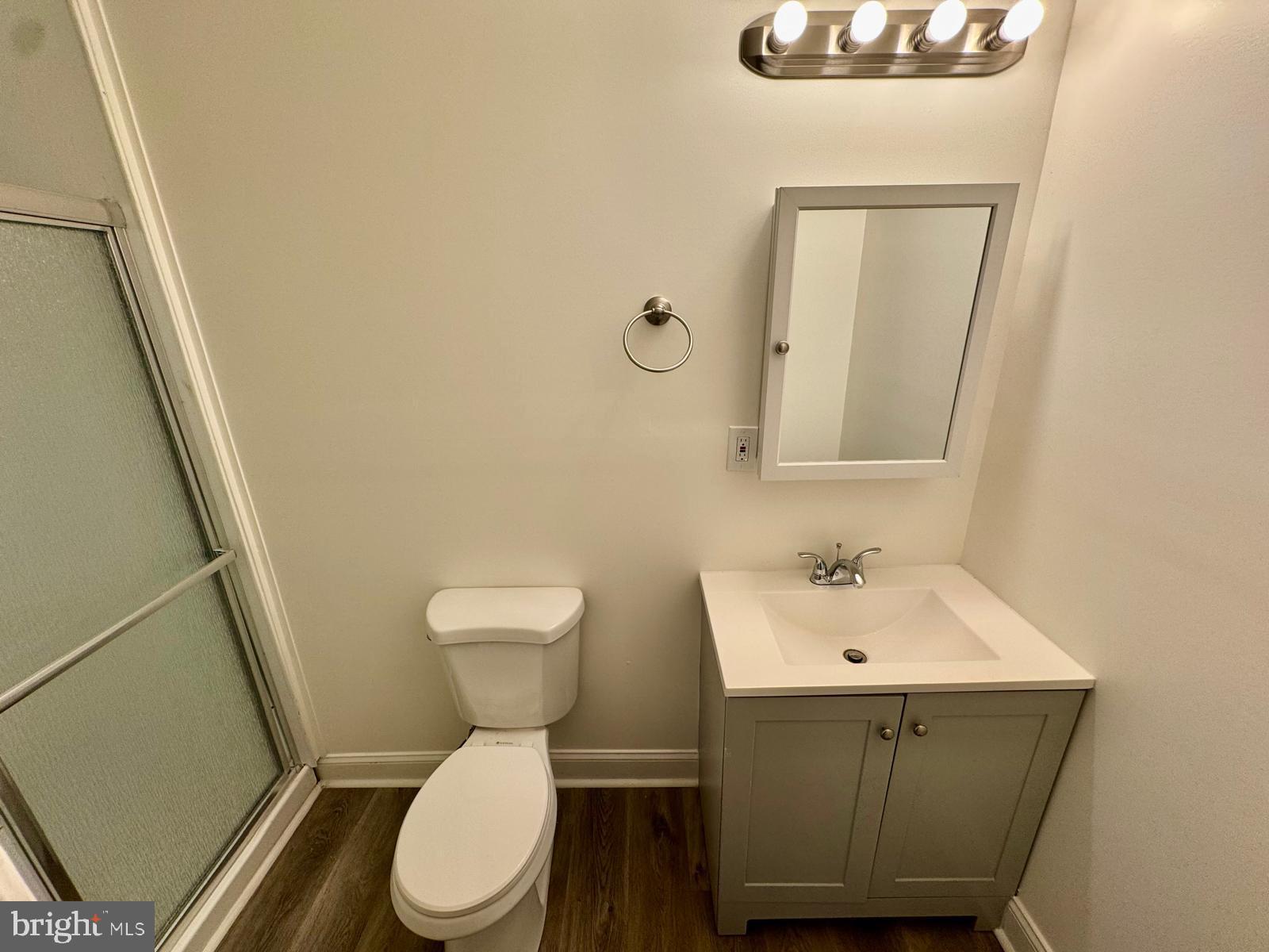 1527 Riggs Avenue Baltimore, MD 21217 - Photo 7 of 16 a bathroom with a toilet a sink and mirror