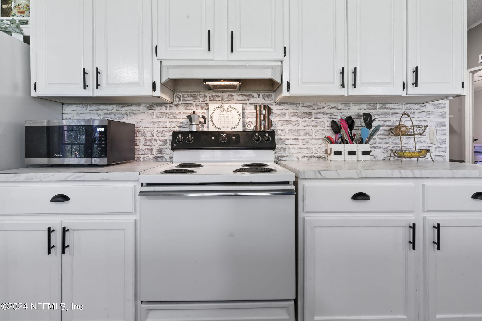 3809 Rancho Road Jacksonville, FL 32221 - Photo 20 of 69 a kitchen with stainless steel appliances granite countertop a sink stove and cabinets