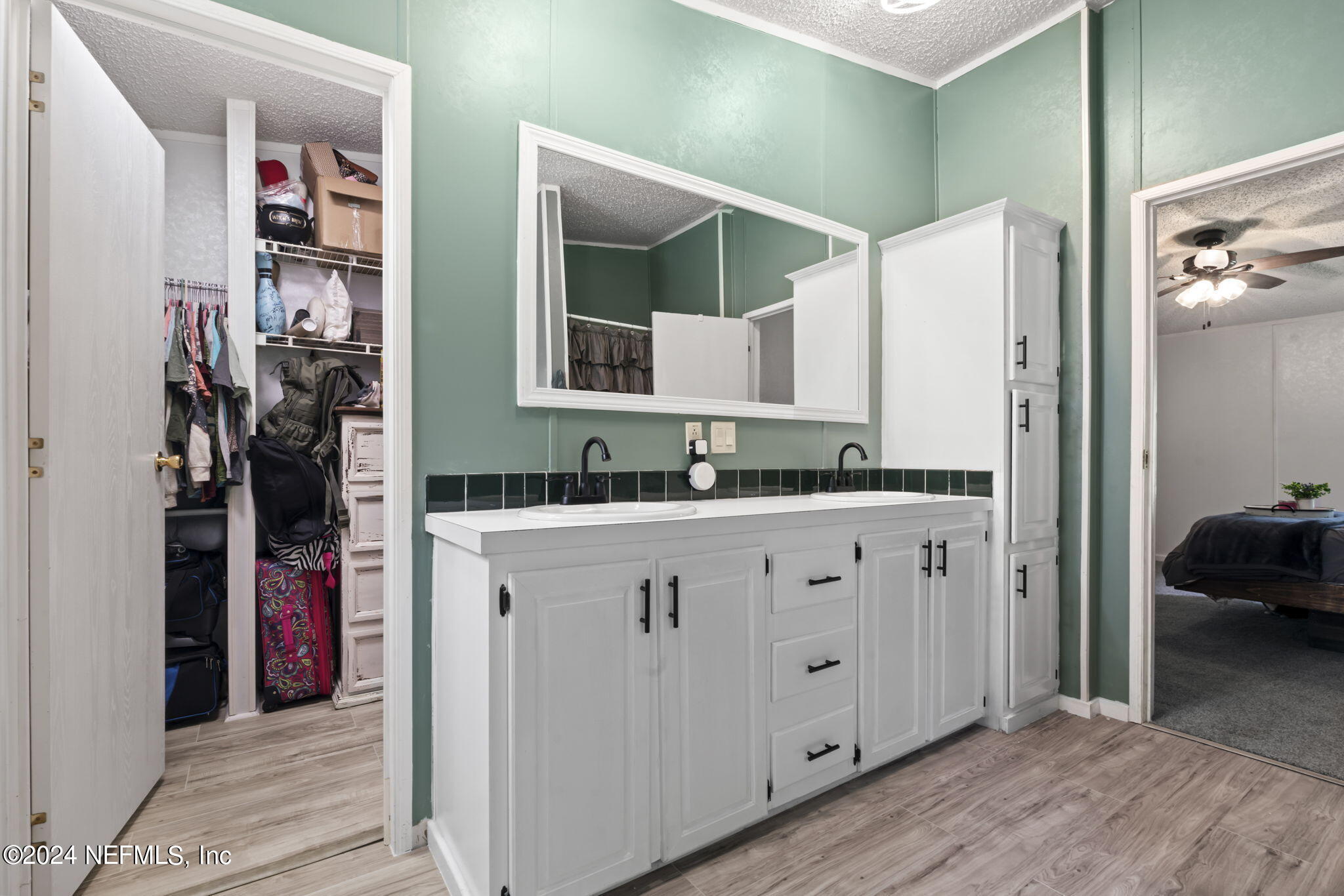 3809 Rancho Road Jacksonville, FL 32221 - Photo 30 of 69 a spacious bathroom with a granite countertop sink and a mirror