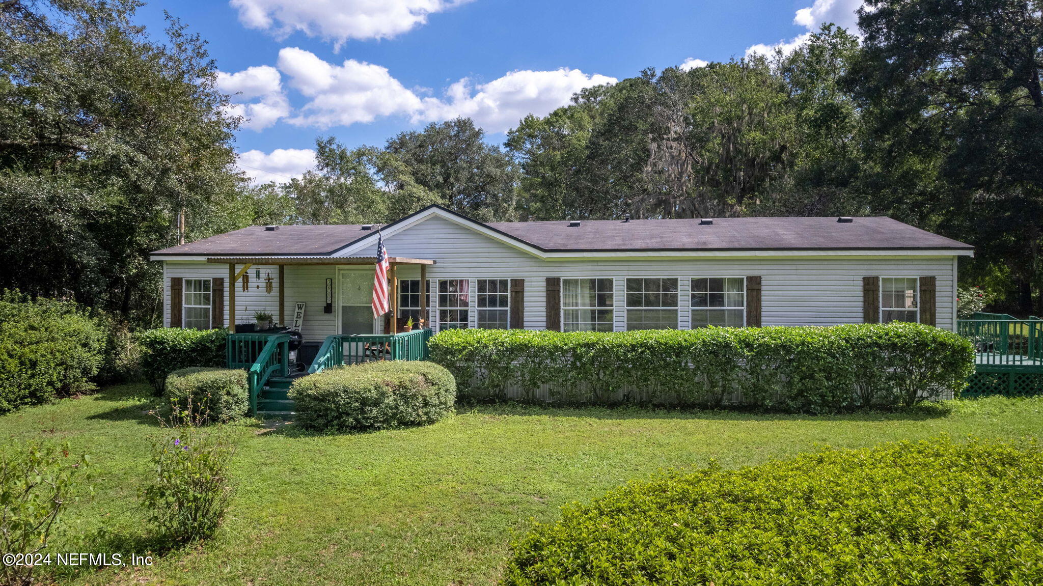 3809 Rancho Road Jacksonville, FL 32221 - Photo 3 of 69 a front view of a house with garden