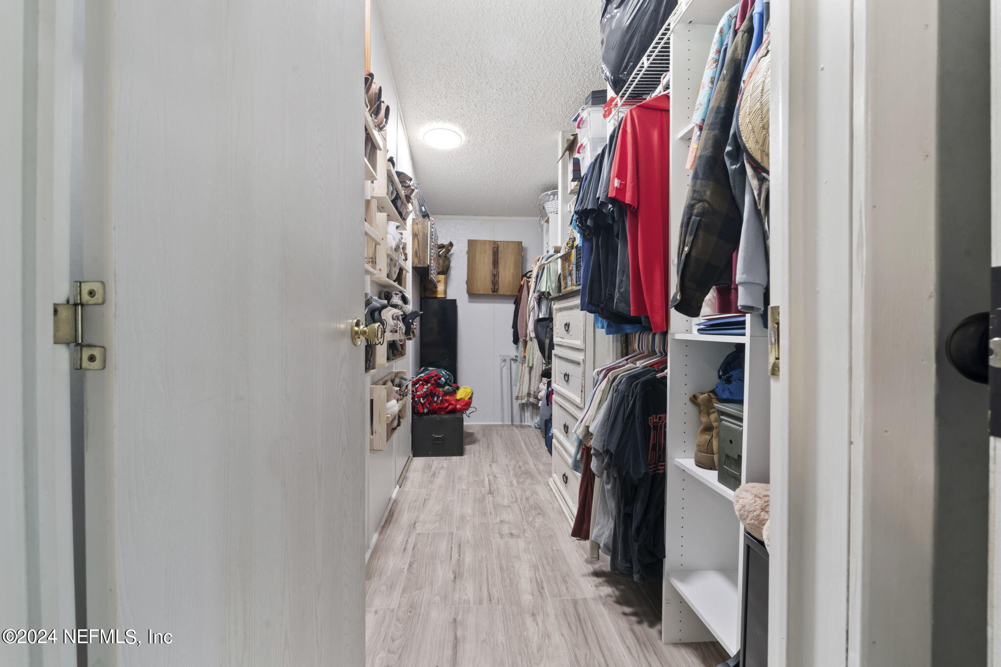 3809 Rancho Road Jacksonville, FL 32221 - Photo 31 of 69 a view of walk in closet with clothes and shoes