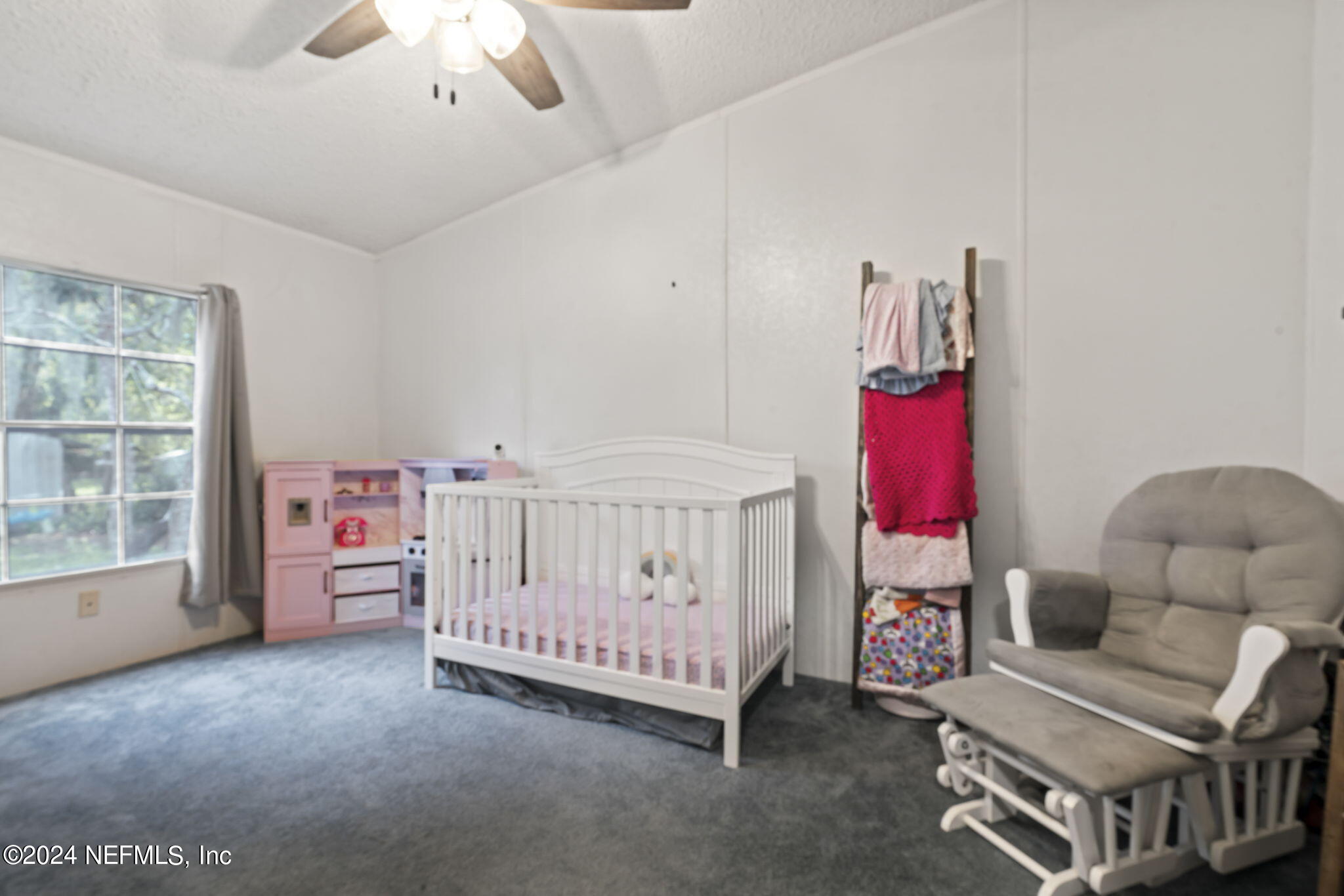 3809 Rancho Road Jacksonville, FL 32221 - Photo 36 of 69 a view of a bedroom with furniture window and a chandelier