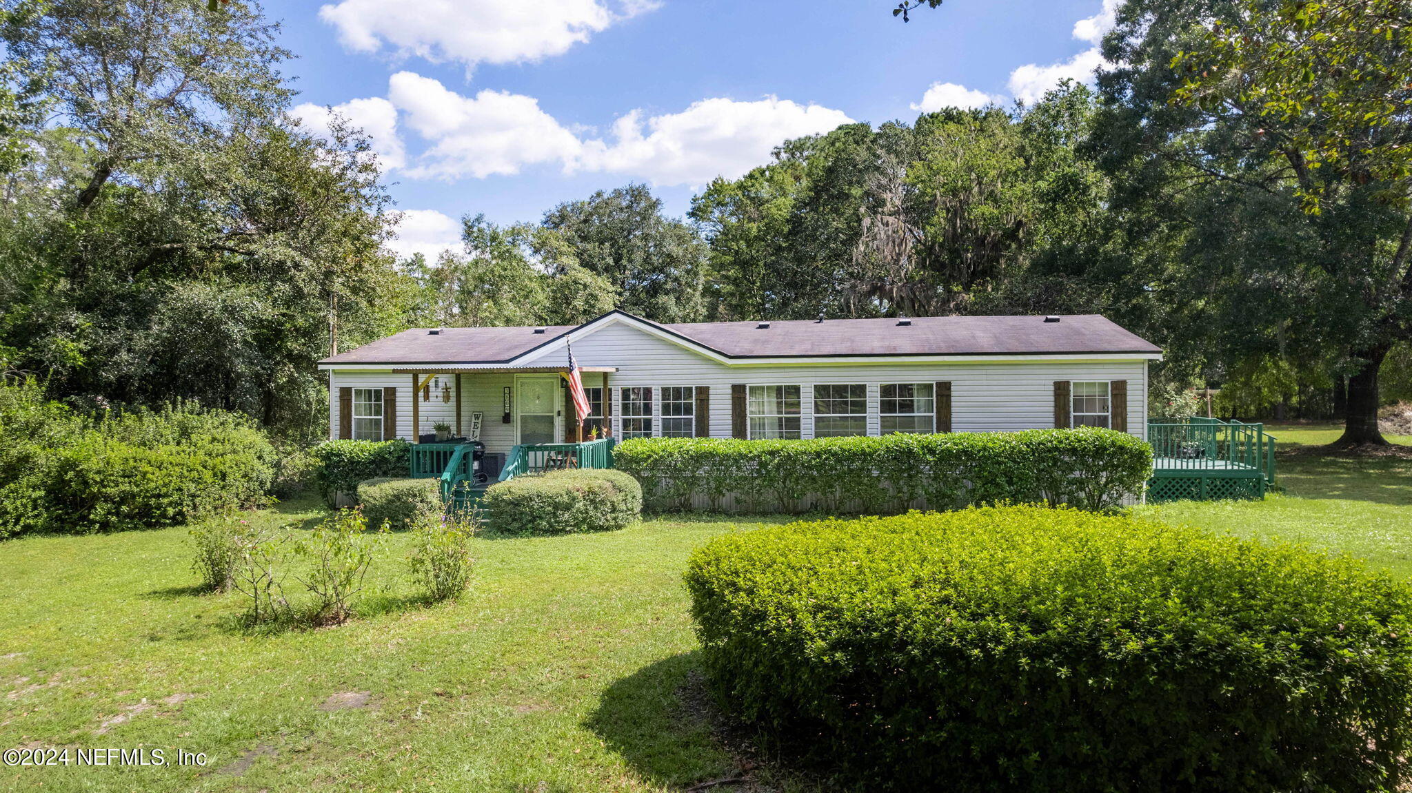 3809 Rancho Road Jacksonville, FL 32221 - Photo 4 of 69 a front view of a house with yard and green space