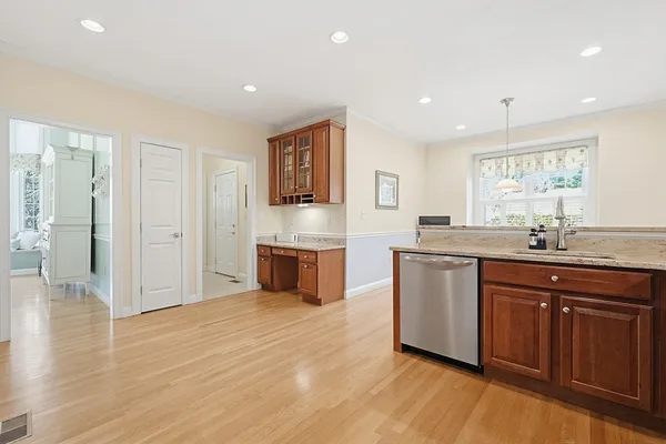 a spacious bathroom with stainless steel appliances granite countertop a sink and a refrigerator