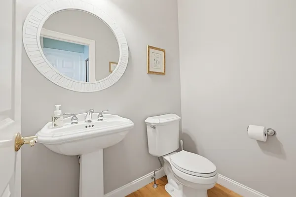 a bathroom with a sink a toilet and a mirror