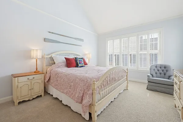 a spacious bedroom with a bed and a couch