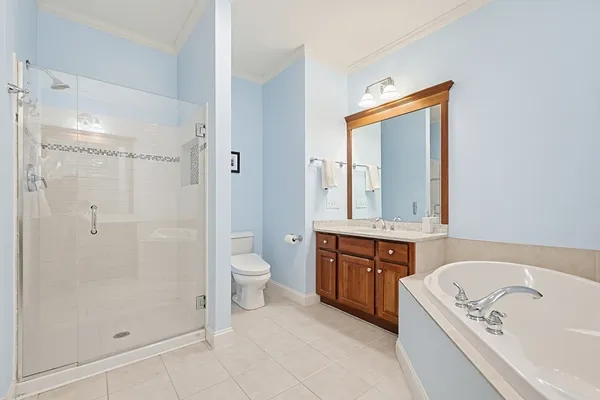 a spacious bathroom with a granite countertop tub sink a mirror a shower and a bathtub