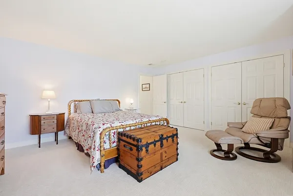 a bedroom with a bed and a chair