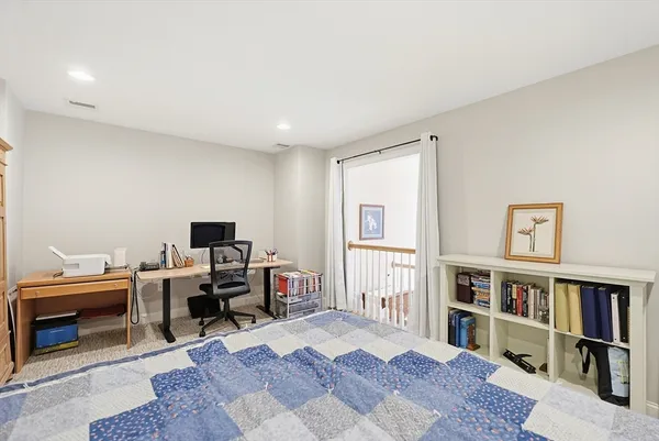 a view of a workspace with furniture and a book shelf