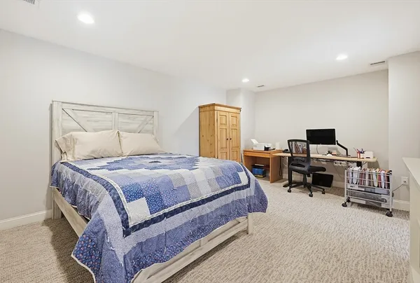 a spacious bedroom with a bed and a flat screen tv
