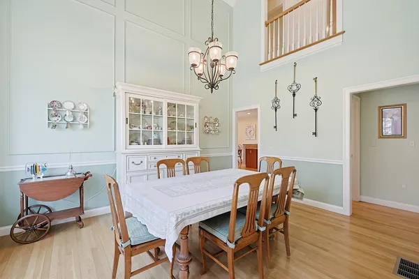 a view of a dining room with furniture wooden floor and chandelier