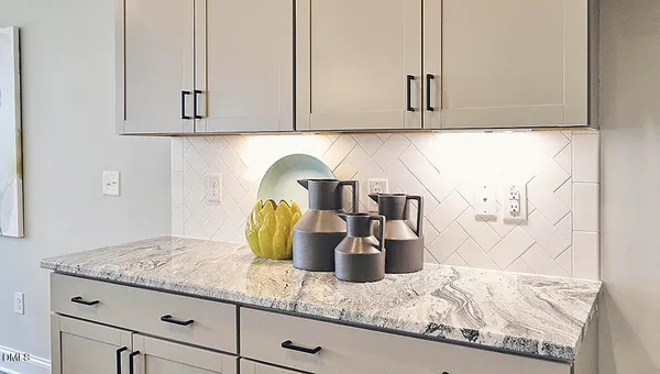 a view of kitchen island with granite countertop living room