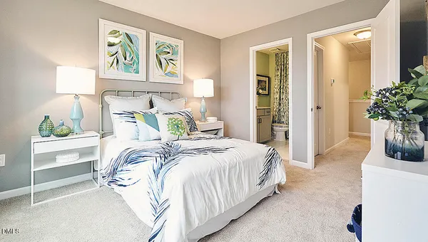 a bedroom with a bed and painting on the wall