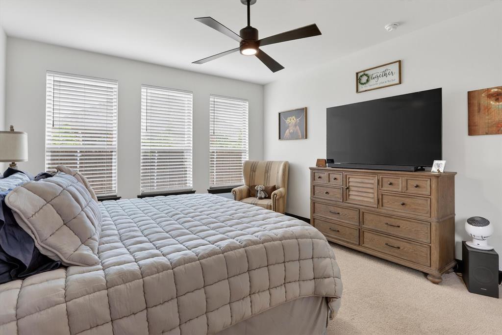 1740 Reverie Road Burleson, TX 76028 - Photo 28 of 37 a bedroom with a bed and a flat screen tv