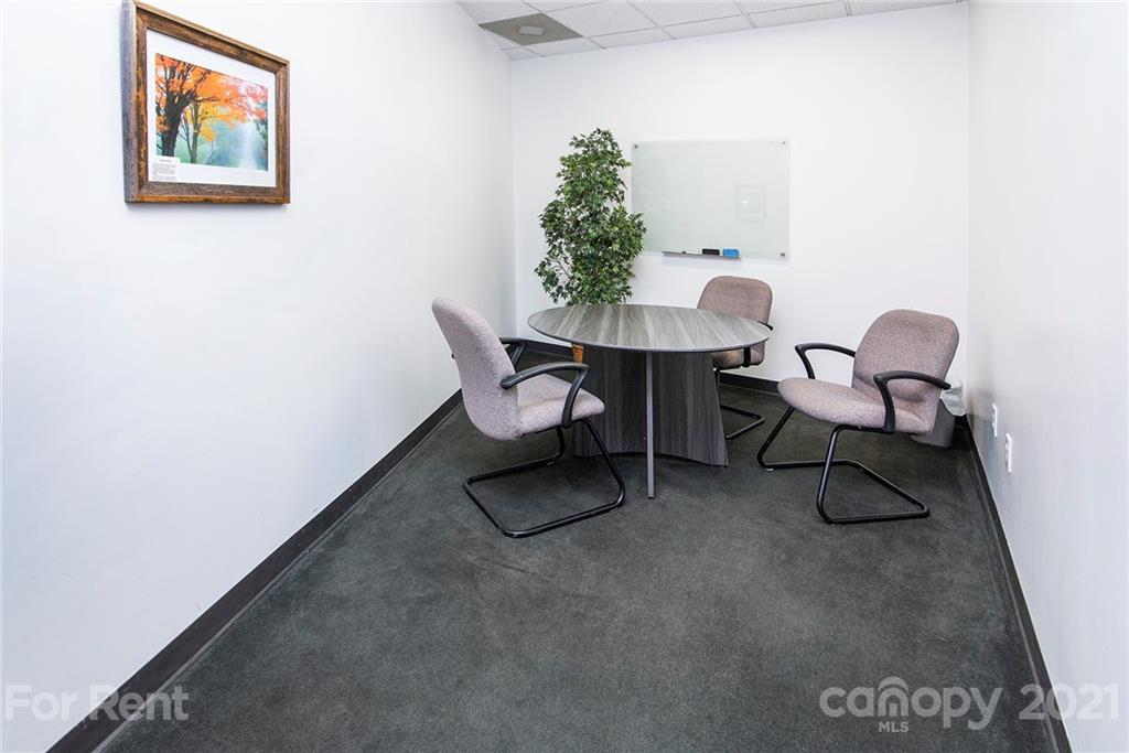 442 South Main Street, Unit 22 Davidson, NC 28036 - Photo 18 of 25 a workspace with furniture and a potted plant