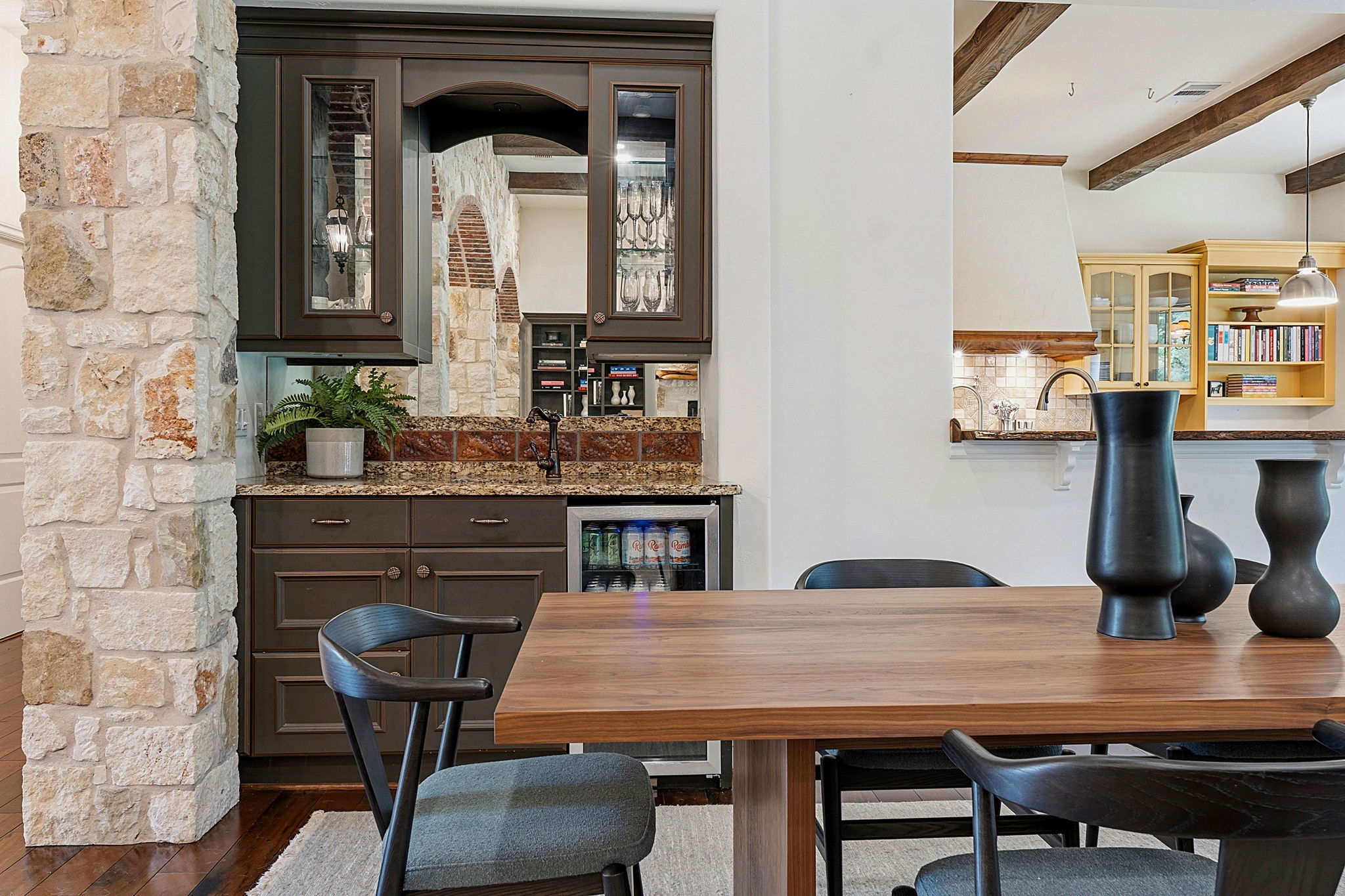 8121 Bluff Trail Austin, TX 78737 - Photo 10 of 40 Custom cabinetry and stone accents define this inviting kitchen and bar area.