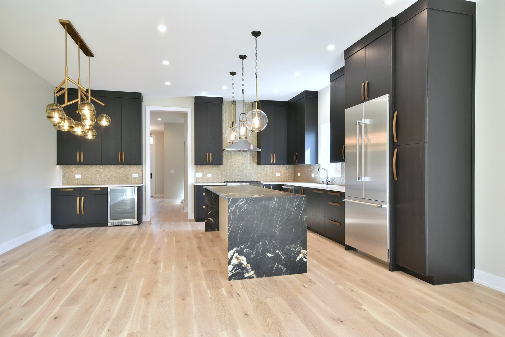 258 North Addison Avenue Elmhurst, IL 60126 - Photo 5 of 13 a large kitchen with stainless steel appliances kitchen island a large counter top and a refrigerator