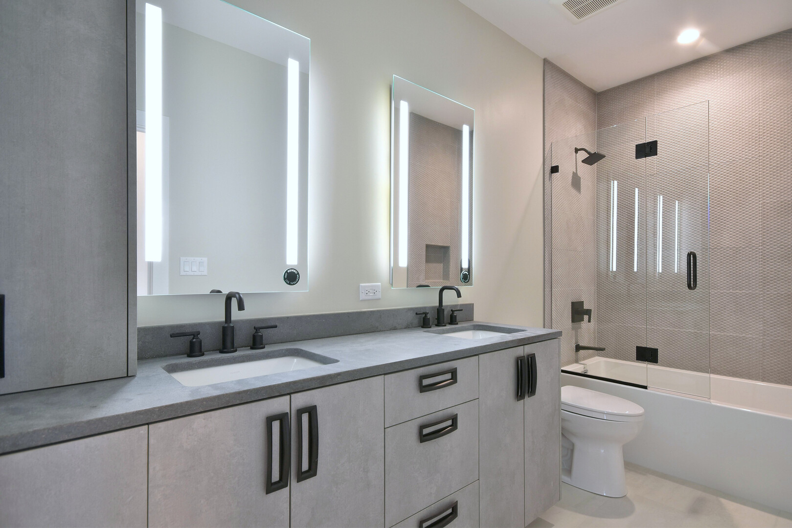 258 North Addison Avenue Elmhurst, IL 60126 - Photo 7 of 13 a bathroom with a granite countertop sink a toilet a mirror and bathtub