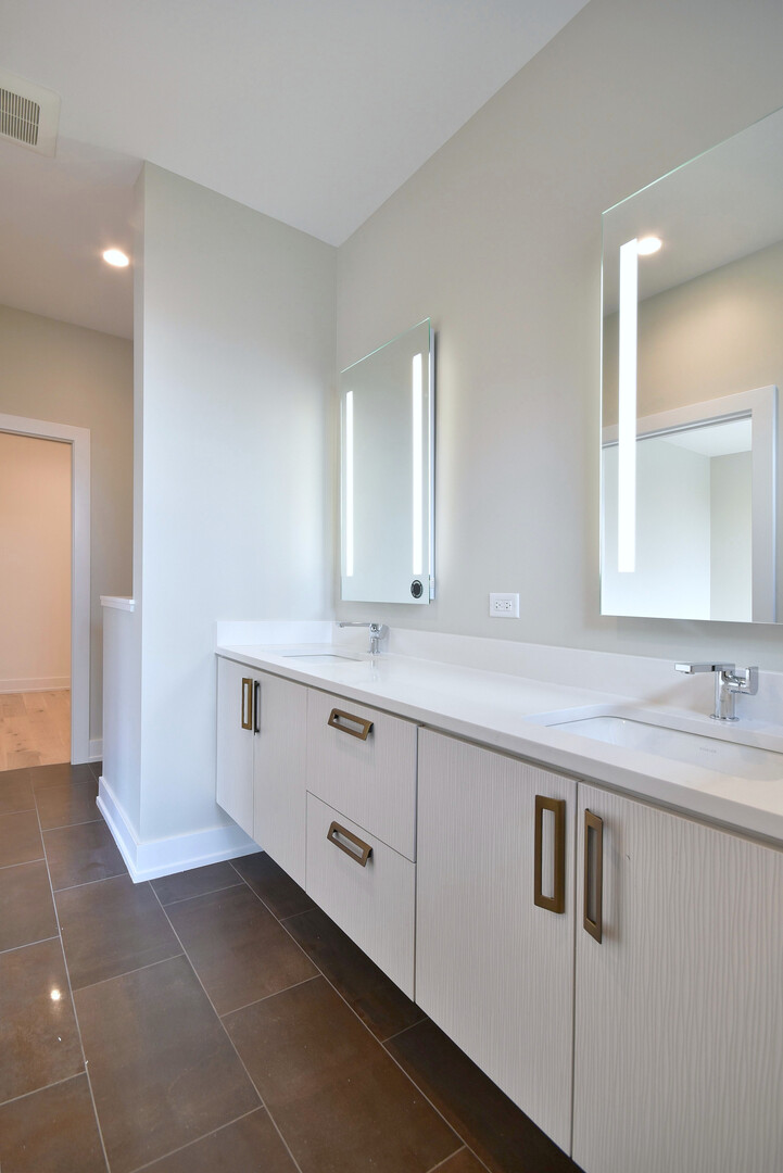 258 North Addison Avenue Elmhurst, IL 60126 - Photo 10 of 13 a bathroom with a double vanity sink and mirror
