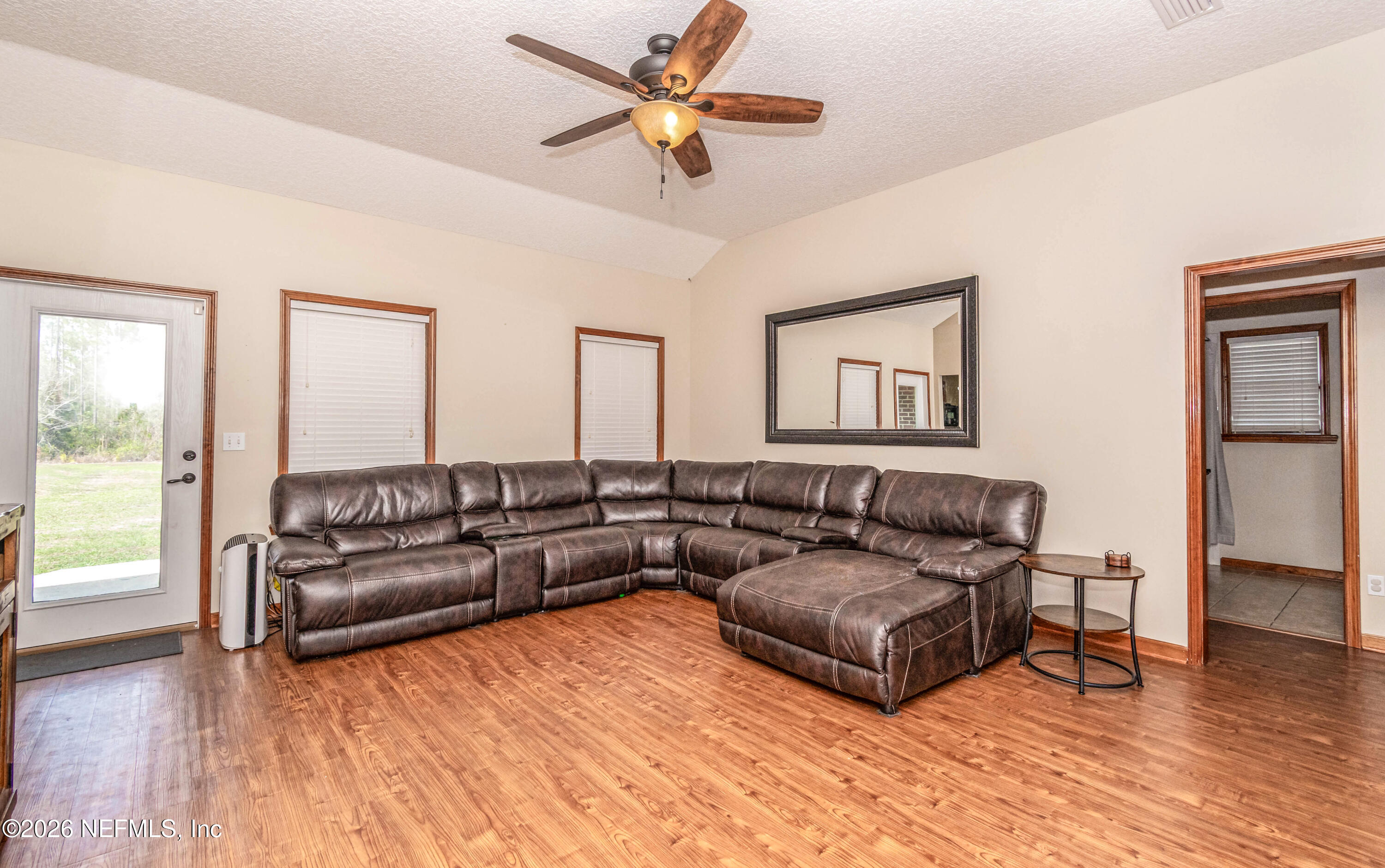 7667 Odis Yarborough Road Glen St. Mary, FL 32040 - Photo 11 of 40 a living room with furniture and a large window