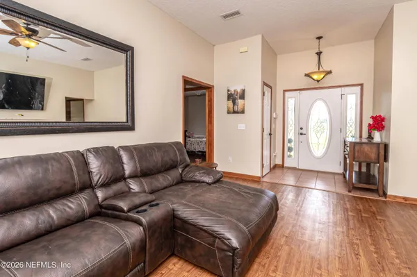 a living room with a couch and a chandelier
