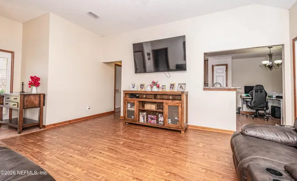 a living room with furniture and a flat screen tv