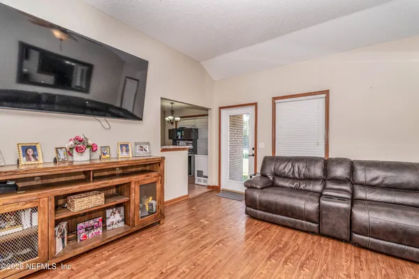a living room with furniture fireplace and flat screen tv