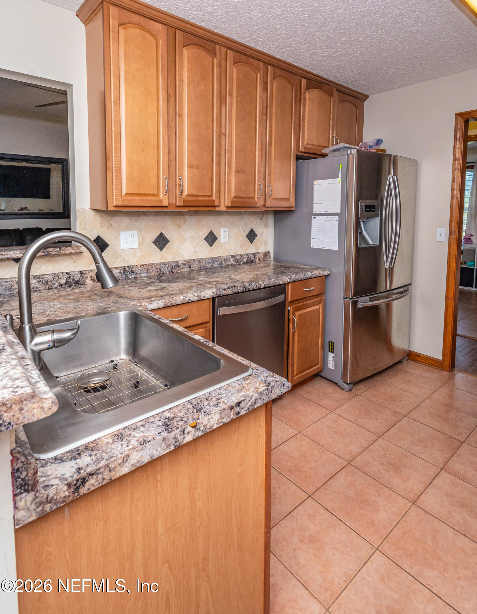 7667 Odis Yarborough Road Glen St. Mary, FL 32040 - Photo 19 of 40 a kitchen with stainless steel appliances granite countertop a sink stove and refrigerator