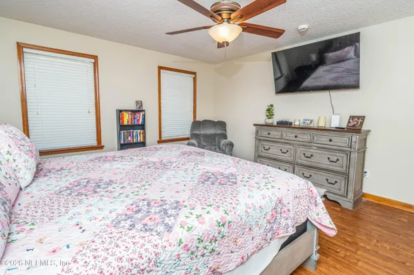 a bedroom with a bed and a flat screen tv